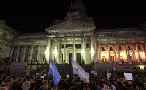 People wave Argentine flags as they attend a demonstration to protest against an agreement between Argentina and Iran outside the Argentine People wave Argentine flags as they attend a demonstration to protest against an agreement between Argentina and Iran outside the Argentine