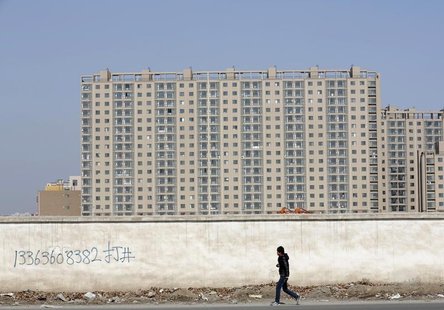 A man walks past a wall at a construction site at a new residential area in Beijing February 27, 2013. REUTERS/Kim Kyung-Hoon A man walks past a wall at a construction site at a new residential area in Beijing February 27, 2013. REUTERS/Kim Kyung-Hoon