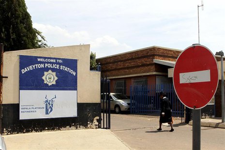 A women enters the Daveyton Police station, east of Johannesburg February 28, 2013. A video of South African police dragging a man for hundr A women enters the Daveyton Police station, east of Johannesburg February 28, 2013. A video of South African police dragging a man for hundr