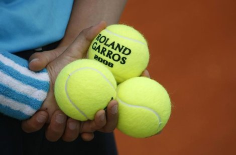 A ball boy holds tennis balls during an exhibition match ahead of the French Open tennis tournament at the Roland Garros stadium in Paris in A ball boy holds tennis balls during an exhibition match ahead of the French Open tennis tournament at the Roland Garros stadium in Paris in