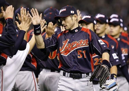 Japan's Ichiro Suzuki (C) celebrates with team mates after defeating South Korea during the World Baseball Classic (WBC) Tokyo round in Toky Japan's Ichiro Suzuki (C) celebrates with team mates after defeating South Korea during the World Baseball Classic (WBC) Tokyo round in Toky