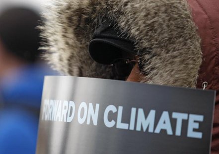 A demonstrator holds a sign during a march against the Keystone XL pipeline in Washington, February 17, 2013. REUTERS/Richard Clement A demonstrator holds a sign during a march against the Keystone XL pipeline in Washington, February 17, 2013. REUTERS/Richard Clement
