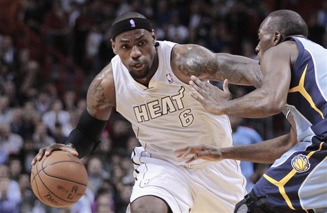 Miami Heat's LeBron James (L) dribbles against Memphis Grizzlies' Quincy Pondexter (R) in the first half of their NBA basketball game in Mia Miami Heat's LeBron James (L) dribbles against Memphis Grizzlies' Quincy Pondexter (R) in the first half of their NBA basketball game in Mia