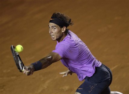 Rafael Nadal of Spain hits a return to compatriot Nicolas Almagro during their men's singles match at the Acapulco International tennis tour Rafael Nadal of Spain hits a return to compatriot Nicolas Almagro during their men's singles match at the Acapulco International tennis tour