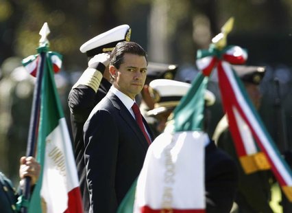 Mexico's President Enrique Pena Nieto looks on during Flag Day celebrations at Campo Marte in Mexico City February 24, 2013. REUTERS/Bernard Mexico's President Enrique Pena Nieto looks on during Flag Day celebrations at Campo Marte in Mexico City February 24, 2013. REUTERS/Bernard