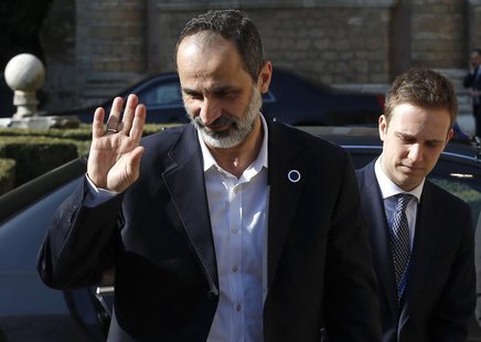 Syrian National Coalition head Moaz al-Khatib (L) waves as he arrives for a meeting with U.S. Secretary of State John Kerry (not pictured) a Syrian National Coalition head Moaz al-Khatib (L) waves as he arrives for a meeting with U.S. Secretary of State John Kerry (not pictured) a