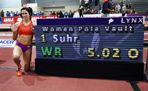 Jenn Suhr poses next to the score board after setting a new women's indoor pole vault world record of 5.02 metres (16 feet 5 1/2 inches) at Jenn Suhr poses next to the score board after setting a new women's indoor pole vault world record of 5.02 metres (16 feet 5 1/2 inches) at