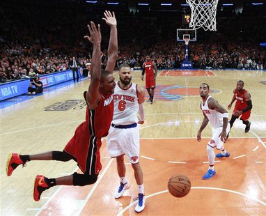 Miami Heat center Chris Bosh reacts after scoring against New York Knicks center Tyson Chandler (6) and guard J.R. Smith (R) in the fourth q Miami Heat center Chris Bosh reacts after scoring against New York Knicks center Tyson Chandler (6) and guard J.R. Smith (R) in the fourth q