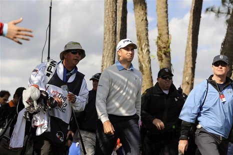 Michael Thompson of the U.S. (C) walks up to the green after hitting onto the green from off the fairway on the 10th hole during the final r Michael Thompson of the U.S. (C) walks up to the green after hitting onto the green from off the fairway on the 10th hole during the final r