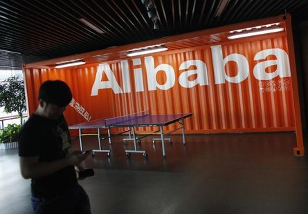 An employee walks past a logo of Alibaba (China) Technology Co. Ltd during a media tour organised by government officials at its headquarter An employee walks past a logo of Alibaba (China) Technology Co. Ltd during a media tour organised by government officials at its headquarter