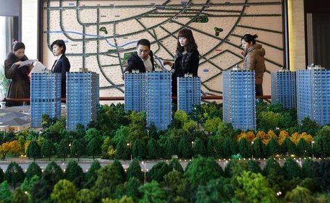 Visitors look around a miniature of new apartment complex at a showroom in Beijing February 27, 2013. REUTERS/Kim Kyung-Hoon Visitors look around a miniature of new apartment complex at a showroom in Beijing February 27, 2013. REUTERS/Kim Kyung-Hoon