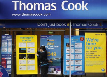 A worker changes the window display of Thomas Cook in Loughborough, central England December 14, 2011. REUTERS/Darren Staples A worker changes the window display of Thomas Cook in Loughborough, central England December 14, 2011. REUTERS/Darren Staples