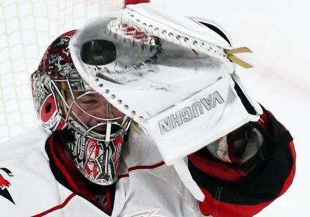 Carolina Hurricanes goalie Cam Ward makes a glove save against the Montreal Canadiens during third period NHL hockey action in Montreal, Feb Carolina Hurricanes goalie Cam Ward makes a glove save against the Montreal Canadiens during third period NHL hockey action in Montreal, Feb