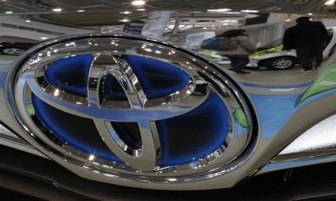 A visitor walking past cars is reflected on a Toyota car at the company's showroom in Tokyo February 5, 2013. REUTERS/Toru Hanai A visitor walking past cars is reflected on a Toyota car at the company's showroom in Tokyo February 5, 2013. REUTERS/Toru Hanai