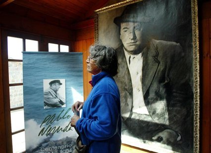 A woman looks at a painting of Chilean poet and Nobel laureate Pablo Neruda during a ceremony the 30th anniversary of his death, in Isla Neg A woman looks at a painting of Chilean poet and Nobel laureate Pablo Neruda during a ceremony the 30th anniversary of his death, in Isla Neg