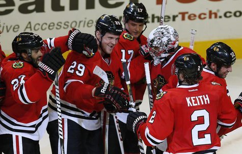 Chicago Blackhawks' goalie Ray Emery (3rd R) is surrounded by teammates after his team's win over the Vancouver Canucks in their NHL hockey Chicago Blackhawks' goalie Ray Emery (3rd R) is surrounded by teammates after his team's win over the Vancouver Canucks in their NHL hockey