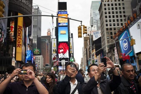 People take photos in Times Square in New York, September 29, 2012. REUTERS/Andrew Burton People take photos in Times Square in New York, September 29, 2012. REUTERS/Andrew Burton