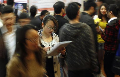 A job seeker looks at her resume during a job fair at a convention center in Shanghai April 7, 2012. REUTERS/Carlos Barria A job seeker looks at her resume during a job fair at a convention center in Shanghai April 7, 2012. REUTERS/Carlos Barria