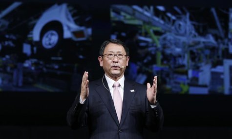 Toyota Motor Corp President Akio Toyoda speaks in front of images of the company's factory during a news conference in Tokyo in this Decembe Toyota Motor Corp President Akio Toyoda speaks in front of images of the company's factory during a news conference in Tokyo in this Decembe