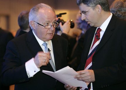 Franz Humer (L), chairman of the board and Severin Schwan, CEO of the Swiss pharmaceutical company Roche, speak before the company's general Franz Humer (L), chairman of the board and Severin Schwan, CEO of the Swiss pharmaceutical company Roche, speak before the company's general