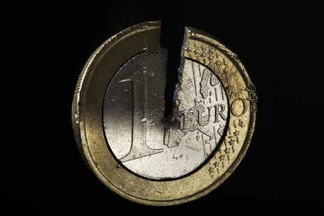 A damaged one Euro coin being held in a vise is pictured in this photo illustration taken in Warsaw September 13, 2012. Picture take Septemb A damaged one Euro coin being held in a vise is pictured in this photo illustration taken in Warsaw September 13, 2012. Picture take Septemb