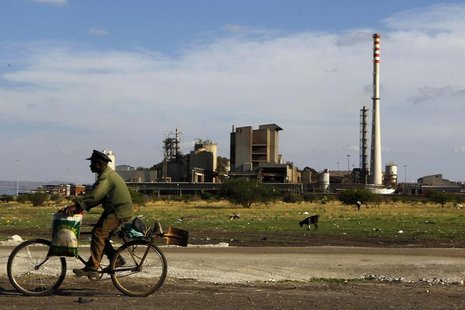 A man rides his bike past the Lonmin mine outside Rustenburg, in the northwest of Johannesburg November 9, 2012. REUTERS/Siphiwe Sibeko A man rides his bike past the Lonmin mine outside Rustenburg, in the northwest of Johannesburg November 9, 2012. REUTERS/Siphiwe Sibeko