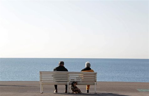 Elderly people sit on a bench to take in the sun with their dog along the Promenade Des Anglais in Nice February 19, 2013. France's Presiden Elderly people sit on a bench to take in the sun with their dog along the Promenade Des Anglais in Nice February 19, 2013. France's Presiden