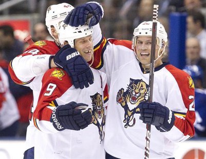 Florida Panthers Stephen Weiss (C) is congratulated by team mates Sean Bergenheim (R) and Erik Gudbranson after he scored against the Toront Florida Panthers Stephen Weiss (C) is congratulated by team mates Sean Bergenheim (R) and Erik Gudbranson after he scored against the Toront