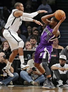 Brooklyn Nets guard C.J. Watson tries to block Sacramento Kings guard Aaron Brooks (3) in the second quarter of their NBA basketball game in Brooklyn Nets guard C.J. Watson tries to block Sacramento Kings guard Aaron Brooks (3) in the second quarter of their NBA basketball game in