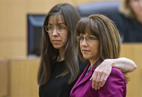 Jodi Arias puts her arm around defense attorney Jennifer Willmott (R), after being asked to demonstrate how she had her arm around her siste Jodi Arias puts her arm around defense attorney Jennifer Willmott (R), after being asked to demonstrate how she had her arm around her siste