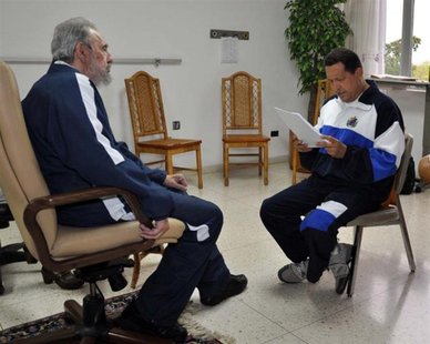 Former Cuban leader Fidel Castro (L) looks on as Venezuela's President Hugo Chavez reads a document in Havana in this July 3, 2011 file hand Former Cuban leader Fidel Castro (L) looks on as Venezuela's President Hugo Chavez reads a document in Havana in this July 3, 2011 file hand