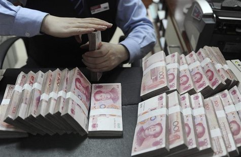 An employee counts Chinese yuan banknotes at a bank in Hefei, Anhui province, in this January 21, 2013 file photo. REUTERS/Stringer/Files An employee counts Chinese yuan banknotes at a bank in Hefei, Anhui province, in this January 21, 2013 file photo. REUTERS/Stringer/Files