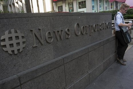 A passer-by stands in front of the News Corporation building in New York June 28, 2012. REUTERS/Keith Bedford A passer-by stands in front of the News Corporation building in New York June 28, 2012. REUTERS/Keith Bedford