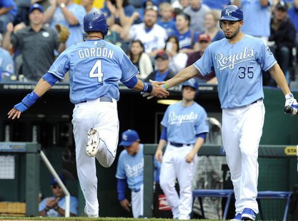 Kansas City Royals Alex Gordon is congratulated by Eric Hosmer (R) after scoring on a Billy Butler double in the first inning against the Ne Kansas City Royals Alex Gordon is congratulated by Eric Hosmer (R) after scoring on a Billy Butler double in the first inning against the Ne