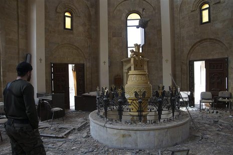 A member of the Free Syrian Army stands inside an Armenian church in Deir al-zor ,March 5, 2013. Picture taken March 5, 2013. REUTERS/Khalil A member of the Free Syrian Army stands inside an Armenian church in Deir al-zor ,March 5, 2013. Picture taken March 5, 2013. REUTERS/Khalil