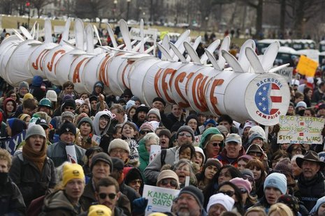Demonstrators carry a replica of a pipeline during a march against the Keystone XL pipeline in Washington, February 17, 2013. REUTERS/Richar Demonstrators carry a replica of a pipeline during a march against the Keystone XL pipeline in Washington, February 17, 2013. REUTERS/Richar