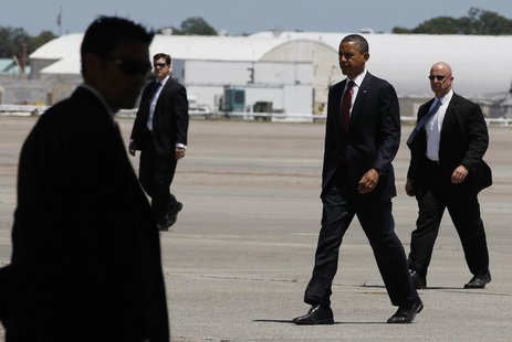 U.S. President Barack Obama walks with U.S. Secret Service agents as he prepares to board Air Force One at Hunter Army Airfield in Georgia b U.S. President Barack Obama walks with U.S. Secret Service agents as he prepares to board Air Force One at Hunter Army Airfield in Georgia b