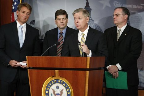 U.S. Senator Lindsey Graham (R-SC) (2nd R) speaks as he leads Senator Jeff Flake (R-AZ) (L), Senator Mark Begich (D-AK) (2nd L) and Senator U.S. Senator Lindsey Graham (R-SC) (2nd R) speaks as he leads Senator Jeff Flake (R-AZ) (L), Senator Mark Begich (D-AK) (2nd L) and Senator