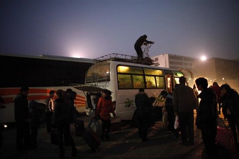 People arrive at a city bus station in the town of Zhoukou, Henan Province for a trip to work in a shoes factory at coastal industrial area People arrive at a city bus station in the town of Zhoukou, Henan Province for a trip to work in a shoes factory at coastal industrial area