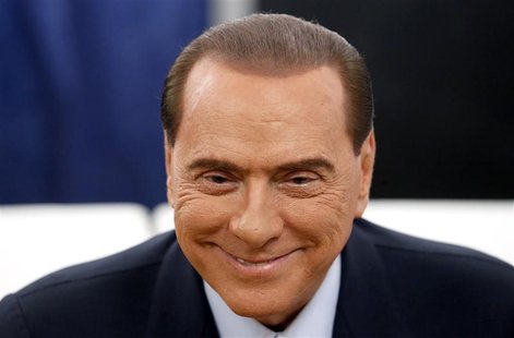 Former Prime Minister Silvio Berlusconi smiles before casting his vote at the polling station in Milan, February 24, 2013. REUTERS/Stefano R Former Prime Minister Silvio Berlusconi smiles before casting his vote at the polling station in Milan, February 24, 2013. REUTERS/Stefano R