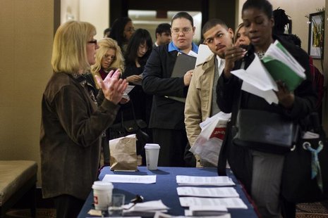 Job seekers adjust their paperwork as they wait in line to attend a job fair in New York February 28, 2013. REUTERS/Lucas Jackson Job seekers adjust their paperwork as they wait in line to attend a job fair in New York February 28, 2013. REUTERS/Lucas Jackson