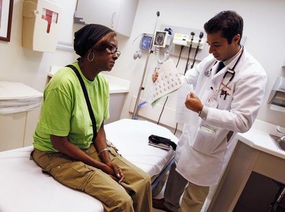 Patient Sharon Dawson Coates (L) listens to Dr. Nikhil Narang after having her knee examined at University of Chicago Medicine Urgent Care C Patient Sharon Dawson Coates (L) listens to Dr. Nikhil Narang after having her knee examined at University of Chicago Medicine Urgent Care C