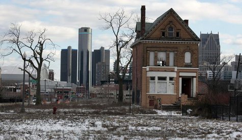 A vacant, boarded up house is seen in the once thriving Brush Park neighborhood with the downtown Detroit skyline behind it in Detroit, Mich A vacant, boarded up house is seen in the once thriving Brush Park neighborhood with the downtown Detroit skyline behind it in Detroit, Mich