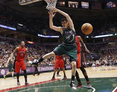Milwaukee Bucks forward Ersan Ilyasova loses the ball as he drives to the basket against the Toronto Raptors during the second half of their Milwaukee Bucks forward Ersan Ilyasova loses the ball as he drives to the basket against the Toronto Raptors during the second half of their