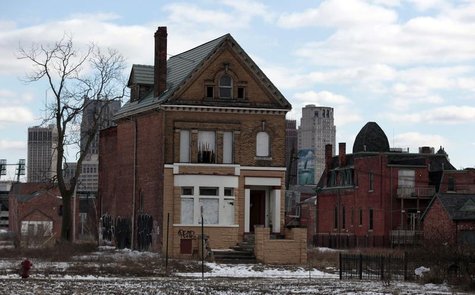 A vacant, boarded up house is seen in the once thriving Brush Park neighborhood with the downtown Detroit skyline behind it in Detroit, Mich A vacant, boarded up house is seen in the once thriving Brush Park neighborhood with the downtown Detroit skyline behind it in Detroit, Mich