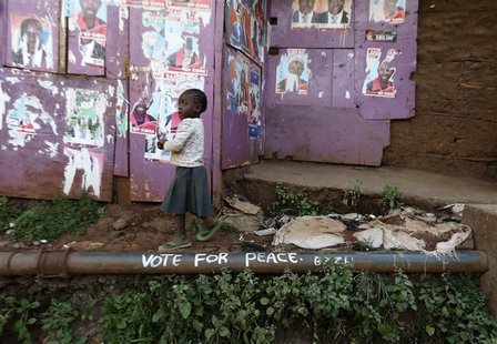 A young girl walks past election posters and a slogan calling for peace in the Kibera slum in Nairobi March 7, 2013. REUTERS/Steve Crisp A young girl walks past election posters and a slogan calling for peace in the Kibera slum in Nairobi March 7, 2013. REUTERS/Steve Crisp