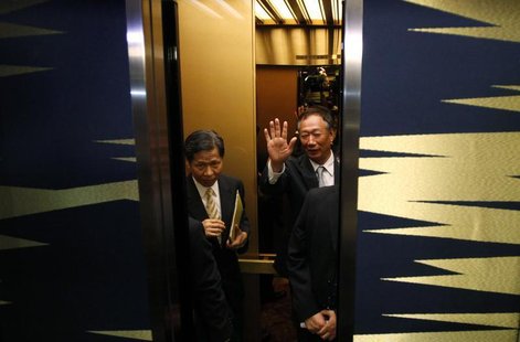 Hon Hai Precision Industry chairman and founder Terry Gou waves to the media as he gets on an elevator after a news conference in Tokyo Augu Hon Hai Precision Industry chairman and founder Terry Gou waves to the media as he gets on an elevator after a news conference in Tokyo Augu