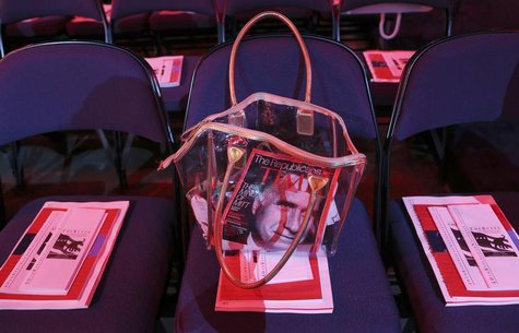 A purse containing the latest issue of Time magazine, with Republican presidential candidate Mitt Romney on the cover, is seen during the se A purse containing the latest issue of Time magazine, with Republican presidential candidate Mitt Romney on the cover, is seen during the se