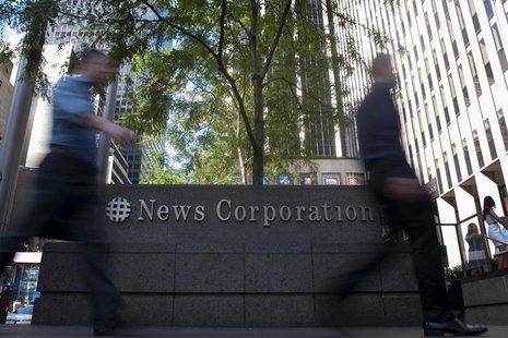 Passers-by walk near the News Corporation building in New York June 28, 2012. REUTERS/Keith Bedford Passers-by walk near the News Corporation building in New York June 28, 2012. REUTERS/Keith Bedford