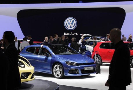Visitors stroll through cars on the Volkswagen booth during the second media day of the 83rd Geneva Car Show at the Palexpo Arena in Geneva Visitors stroll through cars on the Volkswagen booth during the second media day of the 83rd Geneva Car Show at the Palexpo Arena in Geneva
